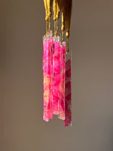 Load image into Gallery viewer, Handmade bookmark with real pressed pink Bougainvillea petals in resin and a gold tassel, placed on an open book
