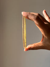 Load image into Gallery viewer, Elegant resin coaster featuring a vibrant green hemp leaf, with its symmetrical design visible through the transparent resin.