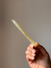 Load image into Gallery viewer, Hand holding an elegant resin coaster with a hemp leaf design, capturing its lightweight and sturdy build