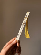 Load image into Gallery viewer, Handmade bookmark with real pressed leaves in resin and a gold tassel, perfect for nature lovers and readers