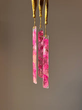 Load image into Gallery viewer, Nature-inspired resin bookmark featuring real pressed pink Bougainvillea petals and gold tassel, displayed on an open book
