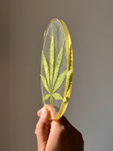 Load image into Gallery viewer, ShopKuhoo handcrafted oval resin hemp leaf coaster with a close-up view, showcasing the delicate natural veins of the hemp leaf encased in resin
